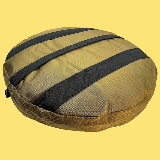 Yellow compression bag with black straps on a yellow background