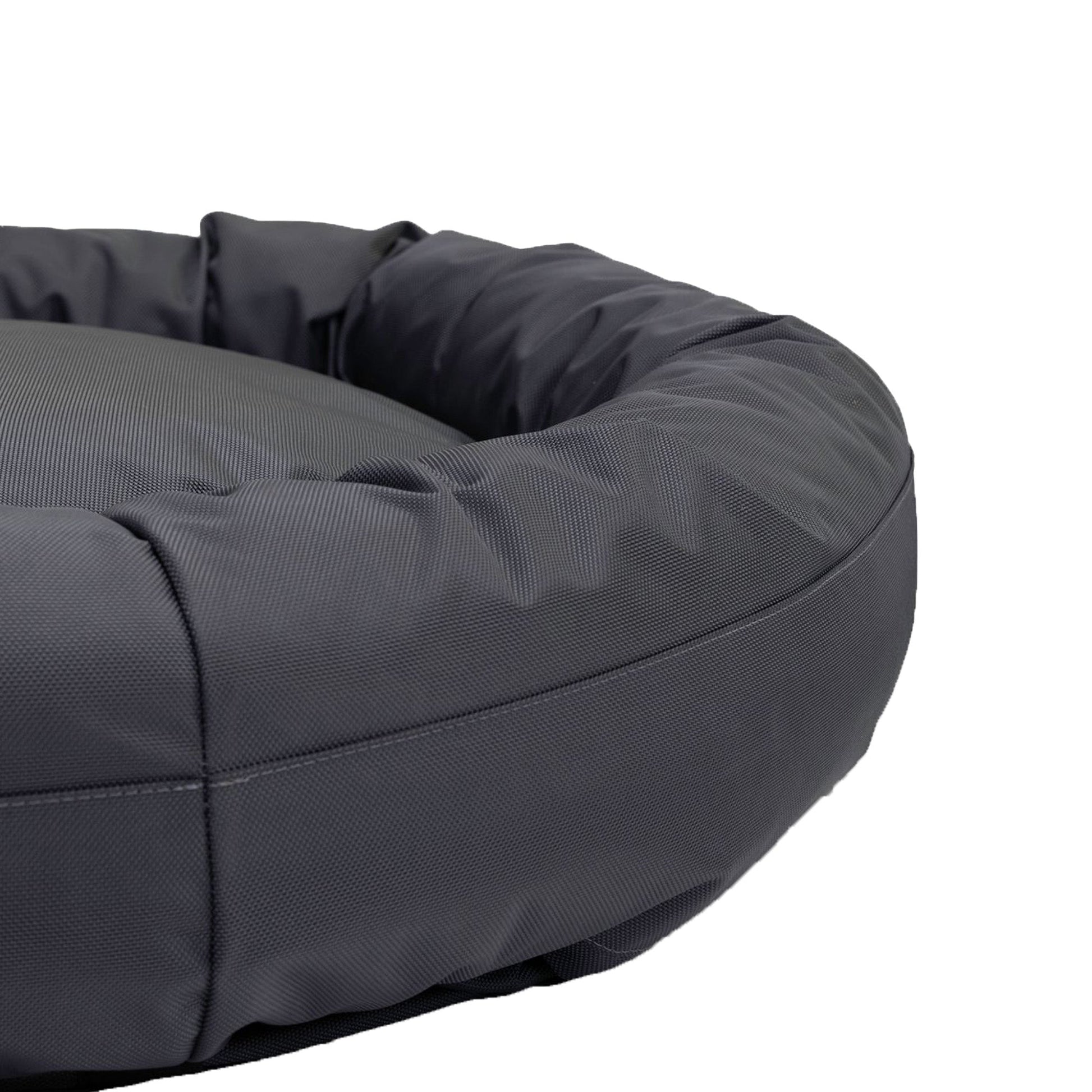 Gray donut-shaped pet bed on a white background
