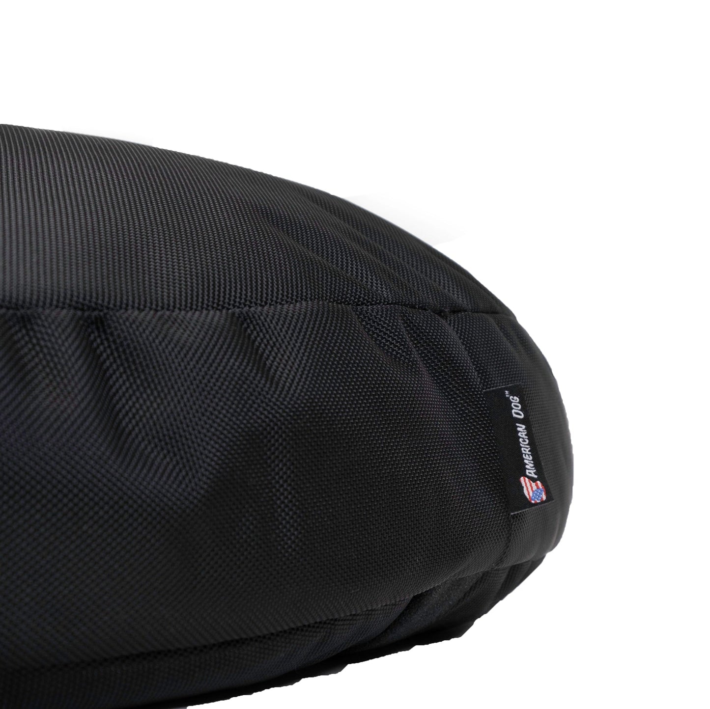 Black dog bed with a visible brand label on a white background