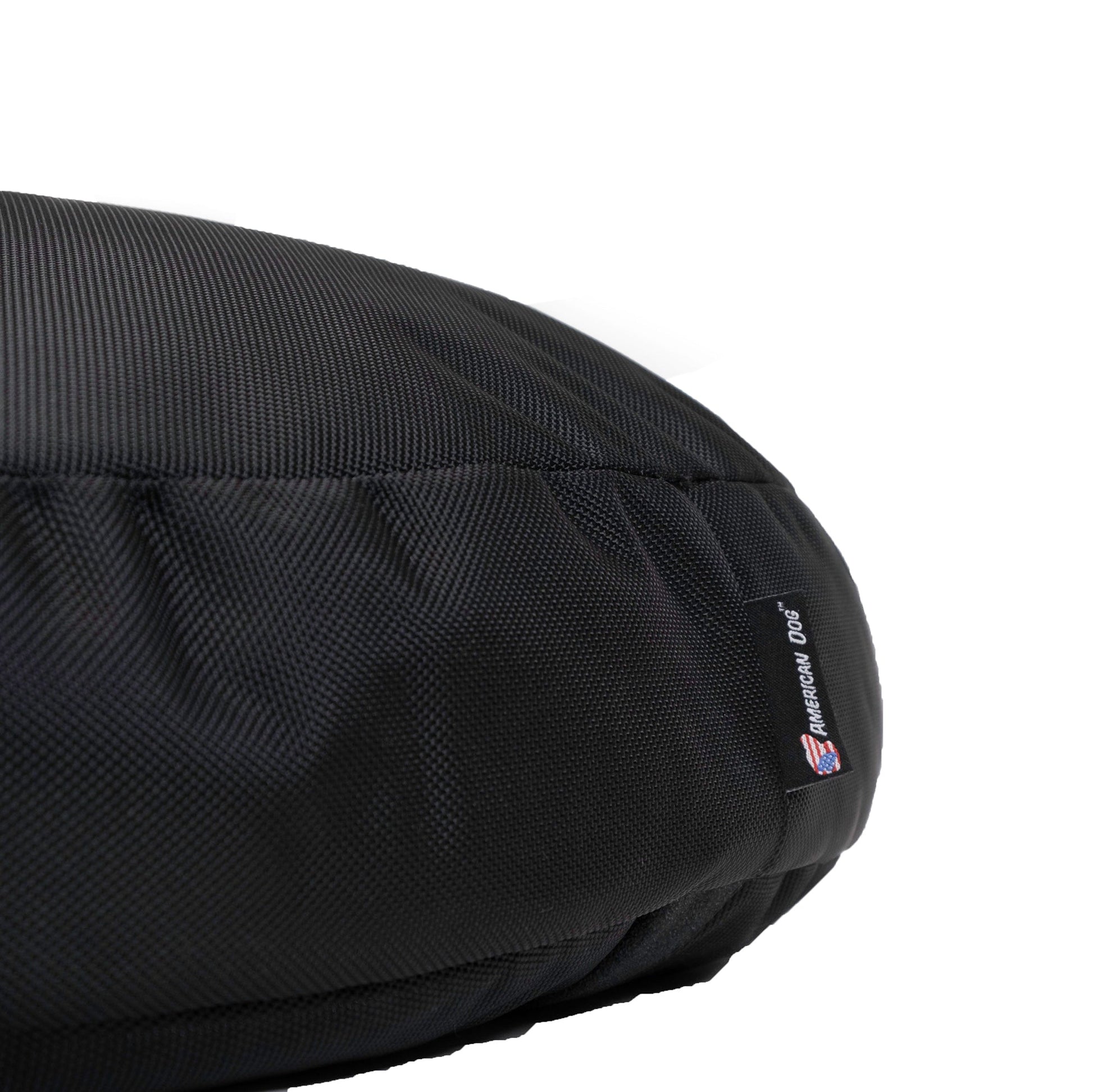 Black dog bed with a visible brand label on a white background