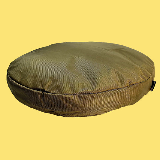 Green round cushion on a yellow background