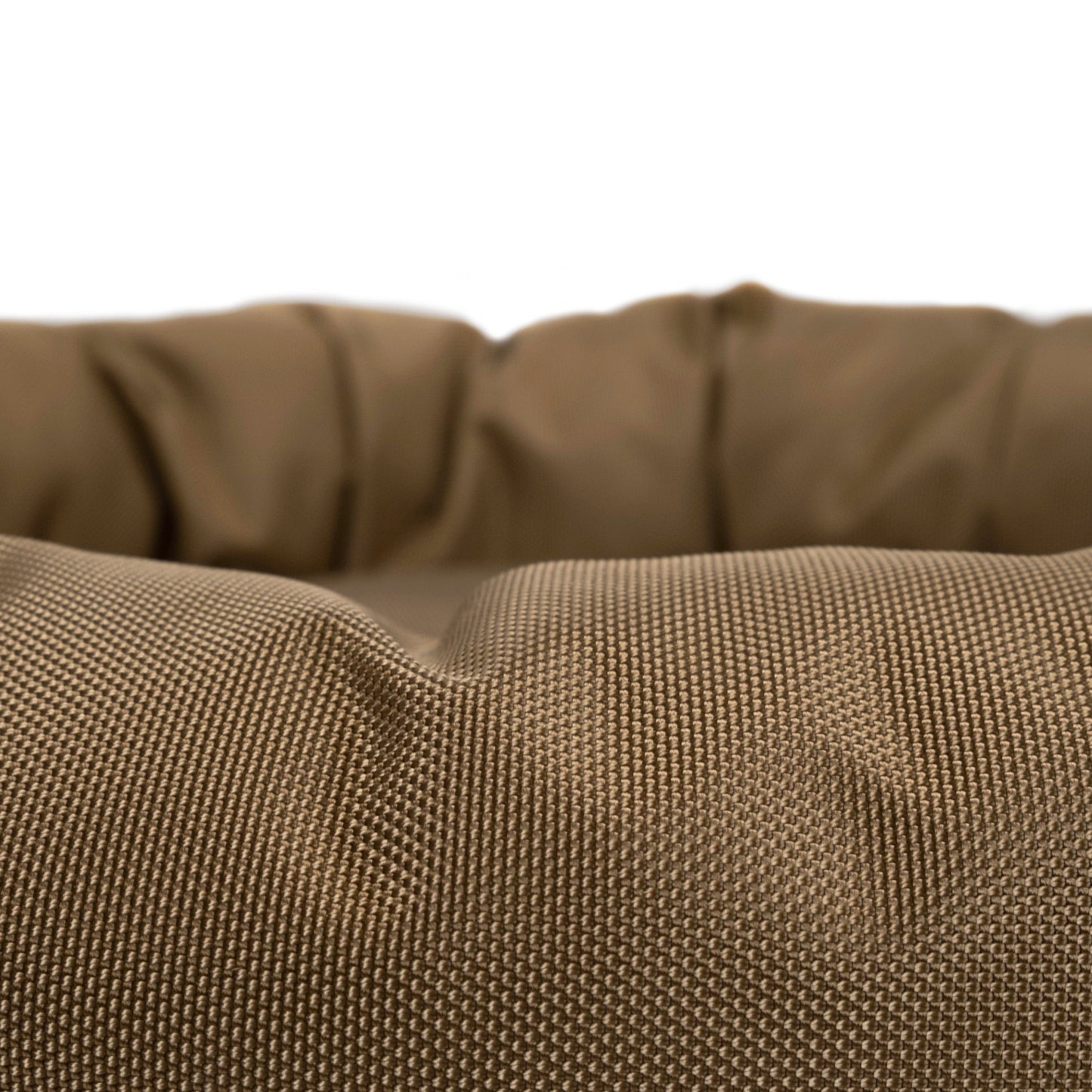 Close-up of a brown textured fabric pet bed on a white background