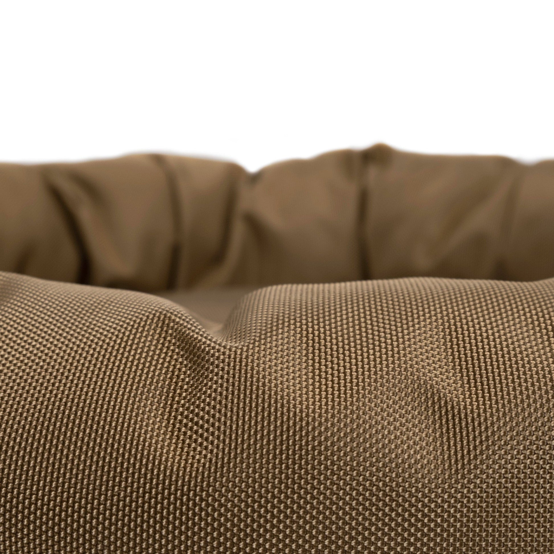 Close-up of a brown textured fabric pet bed on a white background