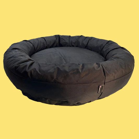 Black round pet bed on a white background