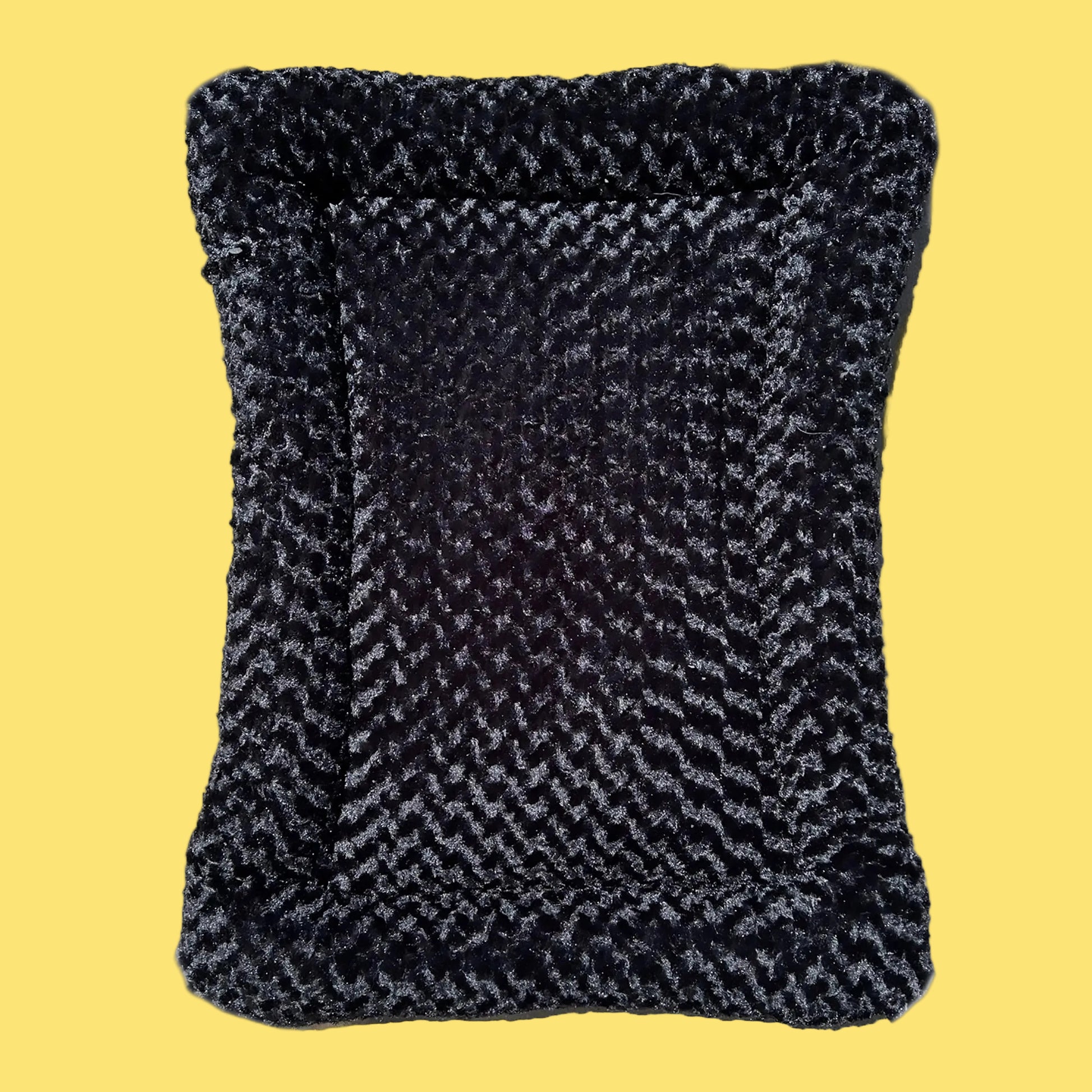 Textured black and gray pillow on a white background