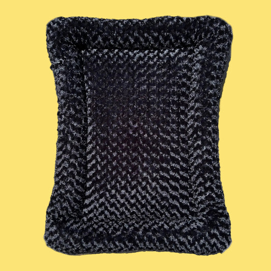 Textured black and gray pillow on a white background