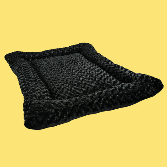 Black pet bed with sherpa lining on a white background