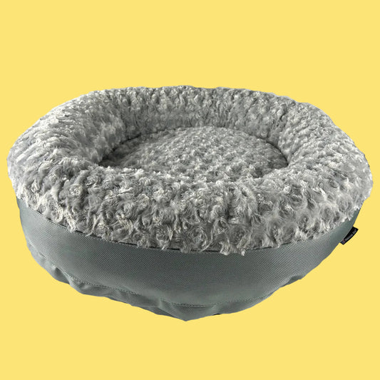 Gray pet bed with textured surface on a white background