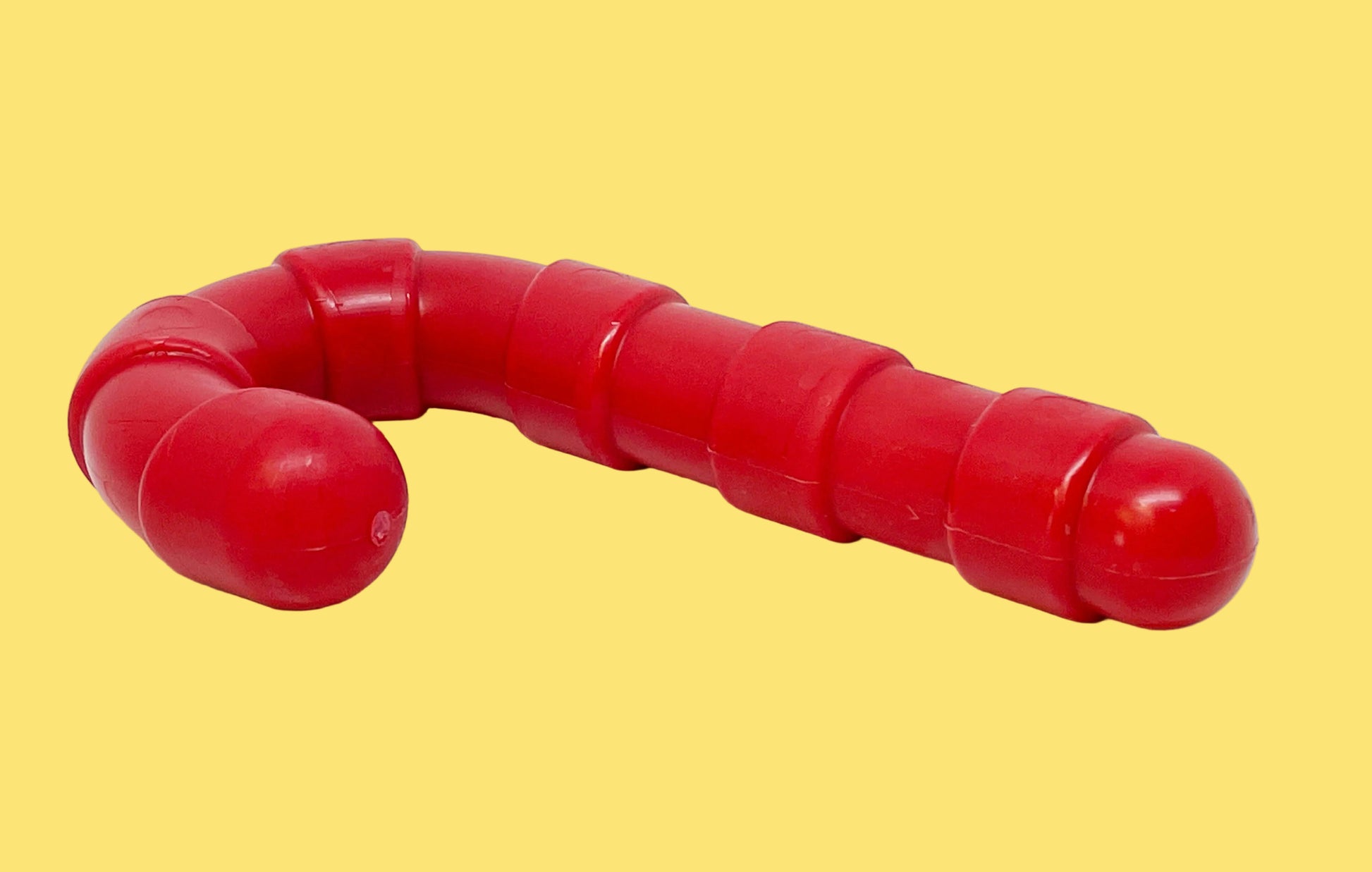 Red dog toy shaped like a snake on a white background