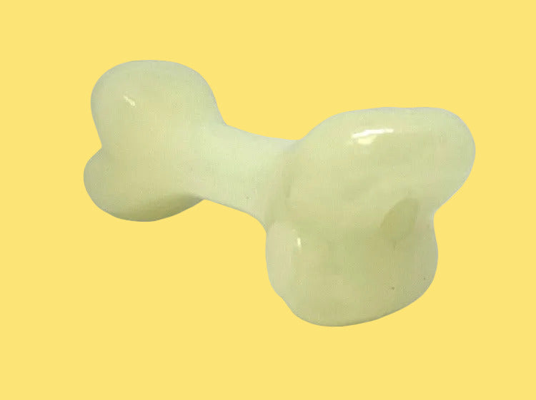 Light green bone-shaped object on a white background