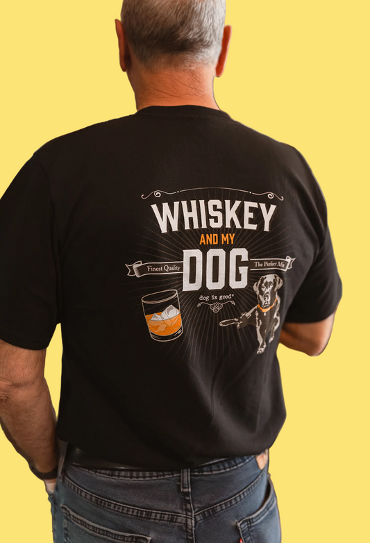 Man wearing a black t-shirt with 'Whiskey and My Dog' design.