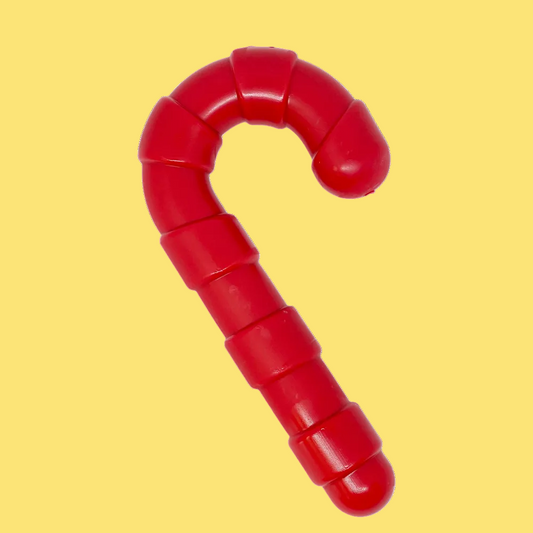 Red plastic toy with a candy cane shape on a white background
